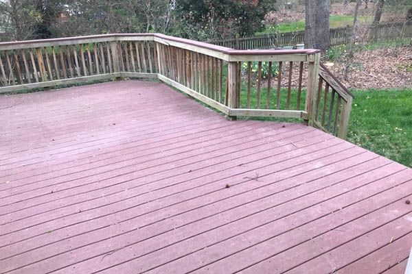 Difference between a deck and patio featuring a faded traditional wood deck