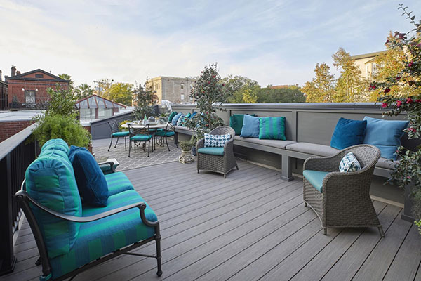 Tall built-in bench backrest adds privacy to a rooftop deck
