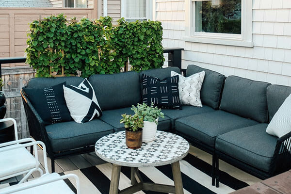 Small trellis covered in ivy adds privacy to deck