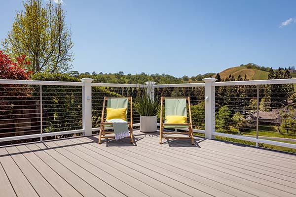 Engineered decking includes capped polymer decking