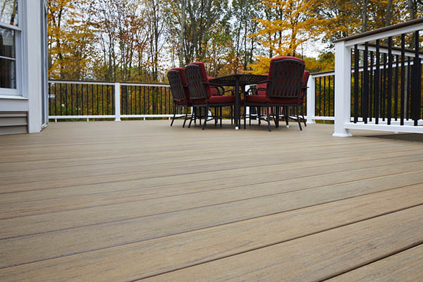 Engineered decking includes capped composite decking