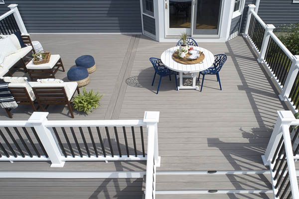 A sunny composite deck with two sections for lounging and dining