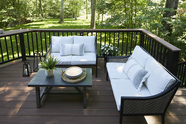 A small woodland composite deck with two loveseats