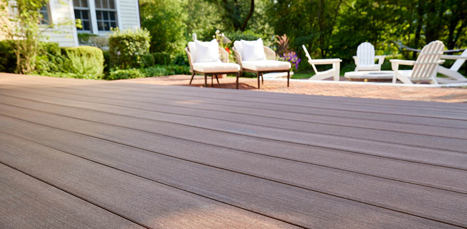 Deck board spacing between deck boards with two lounge chairs on composite deck