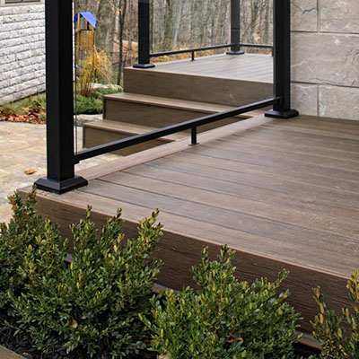Covered deck designs featuring richly-hued composite decking