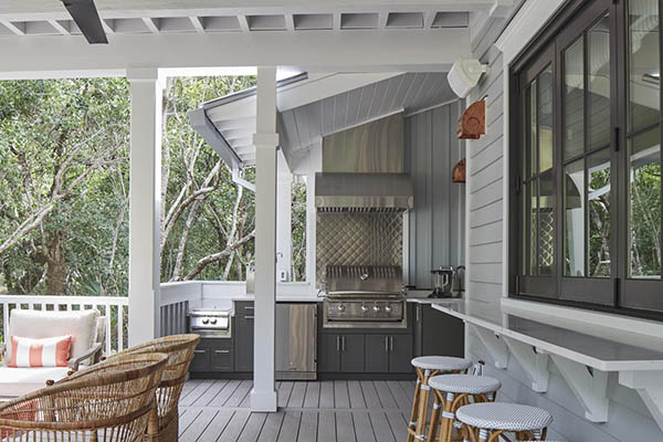 Covered deck designs featuring a built-in outdoor kitchen