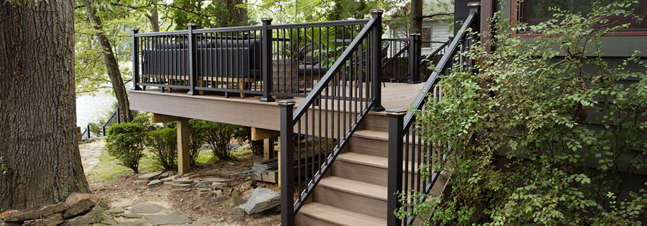 Straight composite deck stairs in a woodland setting