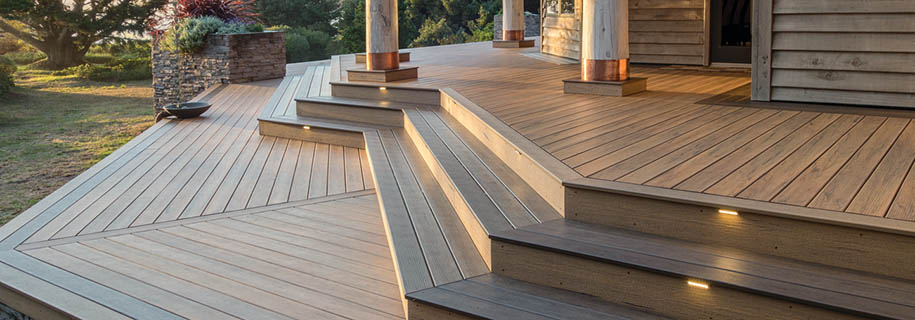 Angled composite deck stairs in a sprawling backyard
