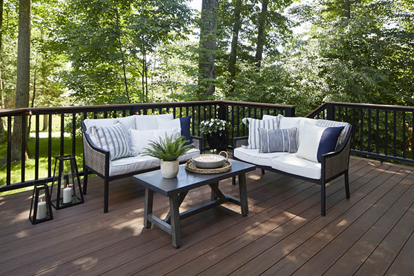 Modern composite decking in a shady woodland area