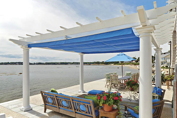 Partially covered deck ideas featuring a white pergola on a beach