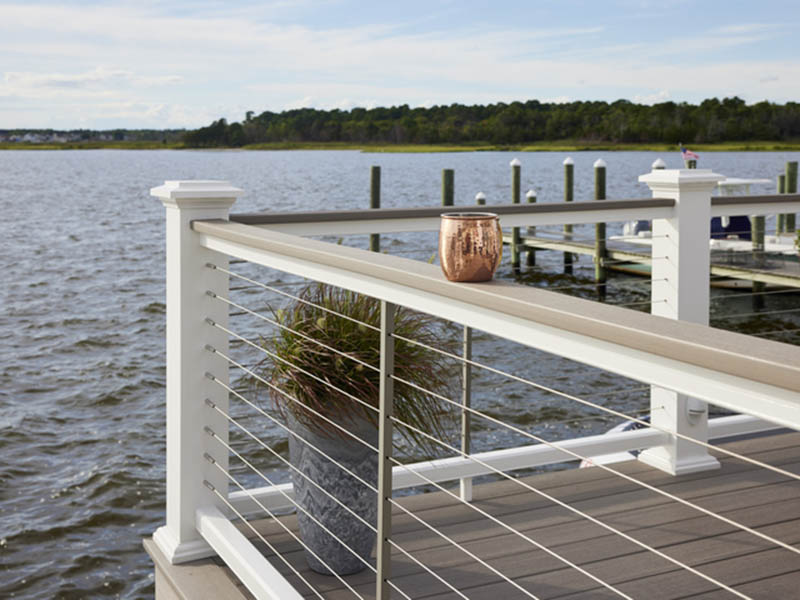 Lakeside deck ideas with bronze cup on railing on dock