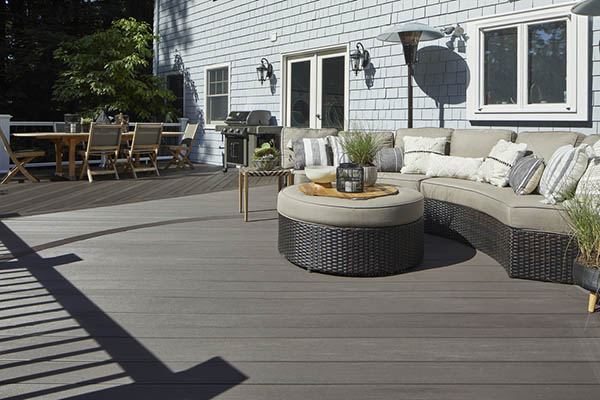 Sunny deck with modern furniture and grill