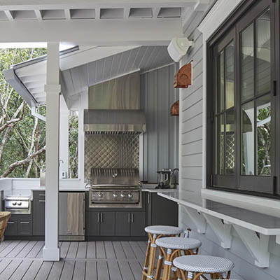 Outdoor kitchen with grill and bar seating