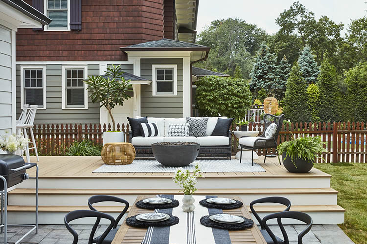 Deck ideas with a multi-level deck with manicured lawn and furniture