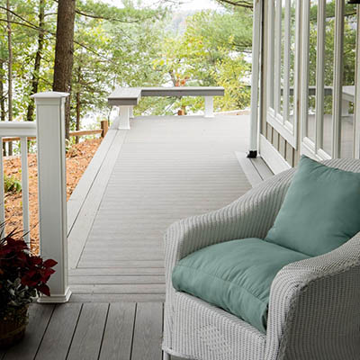 How to plan a deck project featuring wicker seating in wooded area