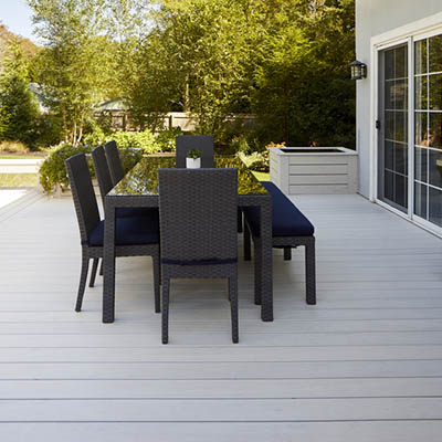 How to plan a deck featuring furnished outdoor deck in backyard with view of trees