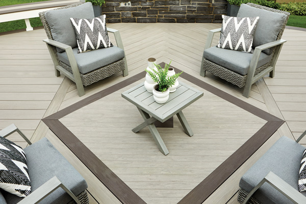 A composite deck with an inlaid square featuring Dark Hickory and Coastline boards