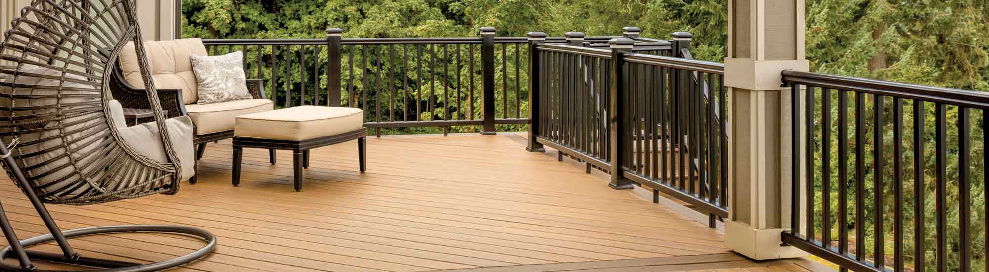 A composite deck featuring Tigerwood boards and RadianceRail Express railing