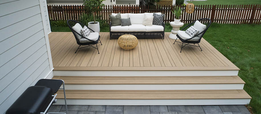 Composite decking vs wood and wood deck vs composite deck featuring small deck in alcove with wicker furniture