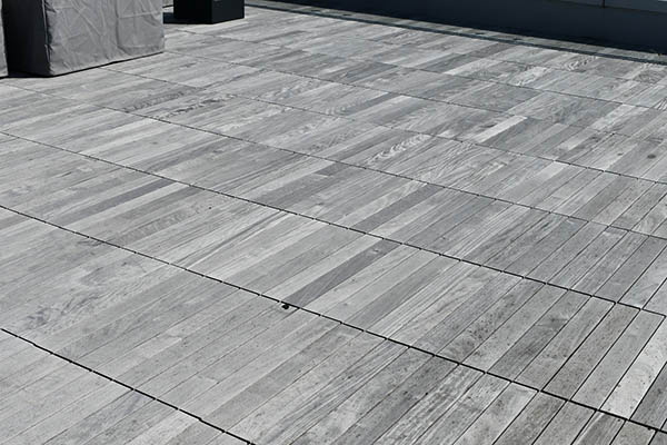 Composite decking vs wood and wood deck vs composite deck featuring worn Ipe decking
