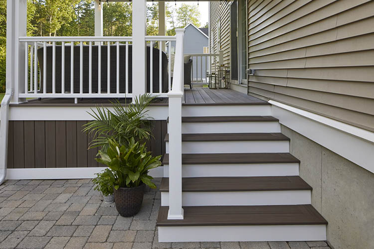 Deck over concrete patio on single family home furnished porch