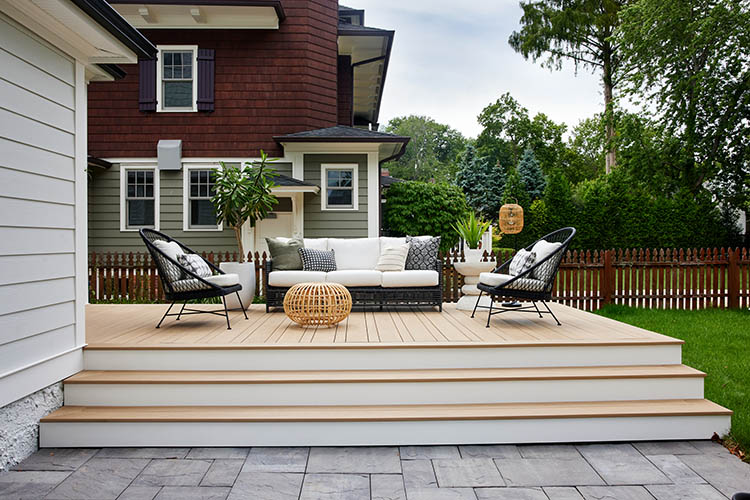 Deck over concrete patio featuring TimberTech AZEK Weather Teak furnished outdoor deck