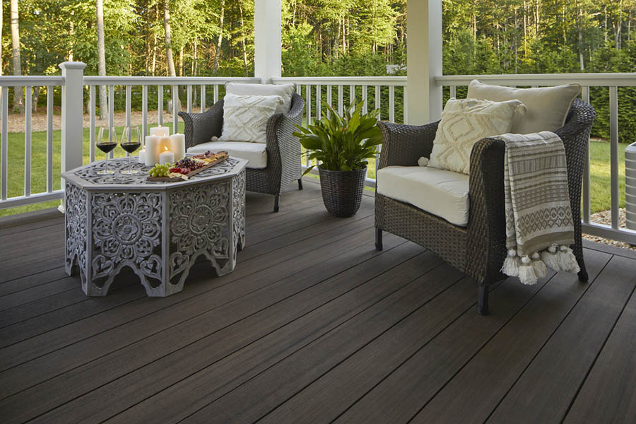 Deck railing ideas and deck baluster ideas on deck with two wicker chairs and an ornate end table