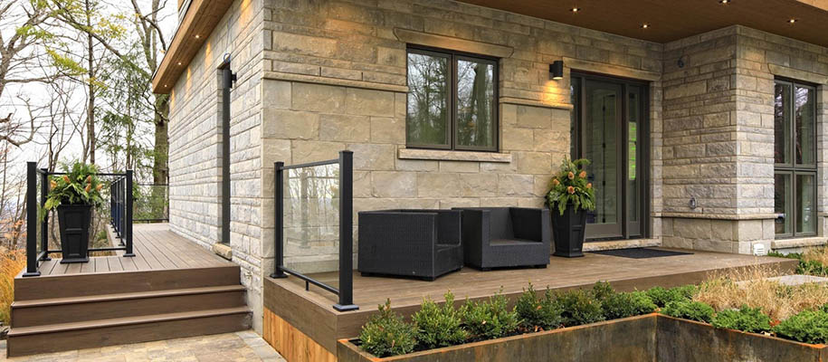 Warm front porch with two chairs and ample planters