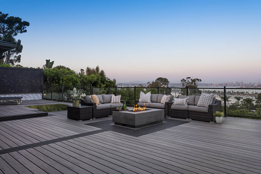 Deck railing ideas on furnished deck overlooking city with firepit