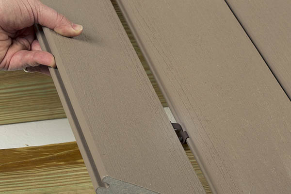 Grooved composite decking installation with hidden clip fasteners