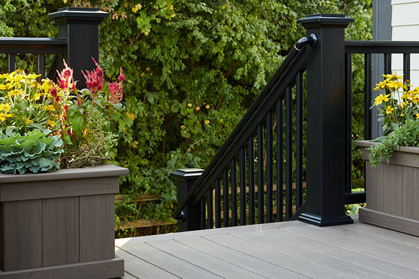 Fall outdoor porch decor ideas include built-in planters with fall foliage