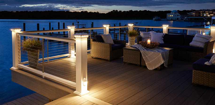 Outdoor fall activities on furnished lakeside deck under cloudy sky