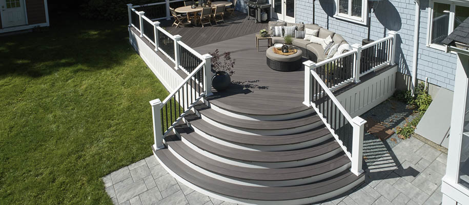 Two tone deck schemes and deck color combinations on sunny furnished deck with curved stairs