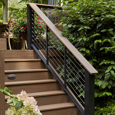 Lush bush next to composite decking stairs with risers
