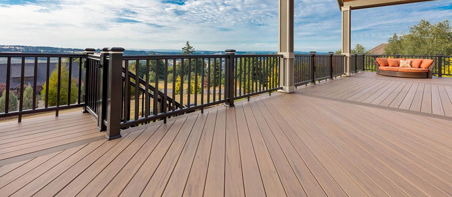 Two tone deck color schemes and deck color combinations featuring a sunny second-story outdoor composite deck with a round chair