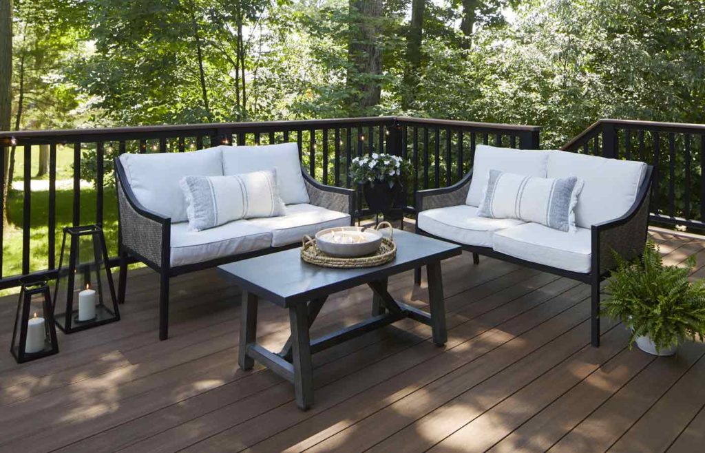 Outdoor sofas on tree-lined composite deck