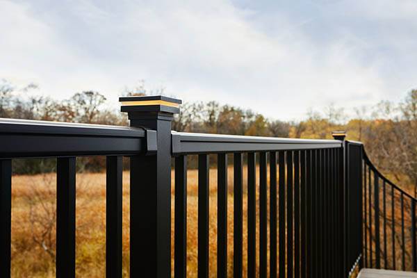 Close-up of metal railing with post cap light