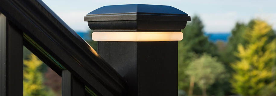 Close-up of black composite railing with post cap light