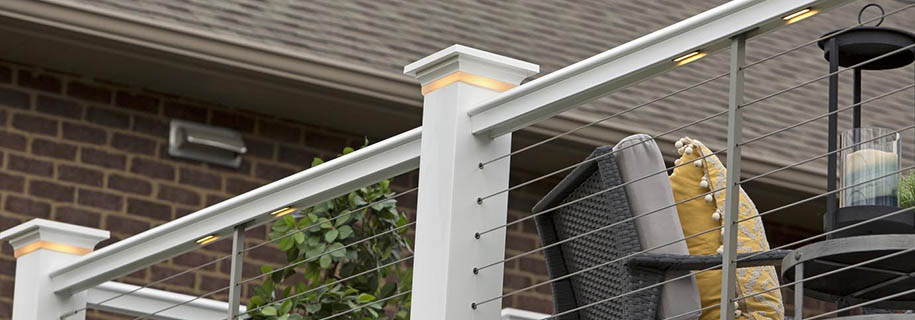 Shot from below of a deck railing with under rail lights and post cap lights