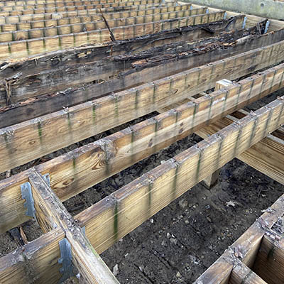 Deck damage can be seen in a wood deck's substructure