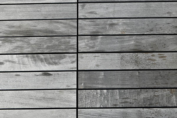 Ipe wood deck close-up shows signs of cracking and splintering