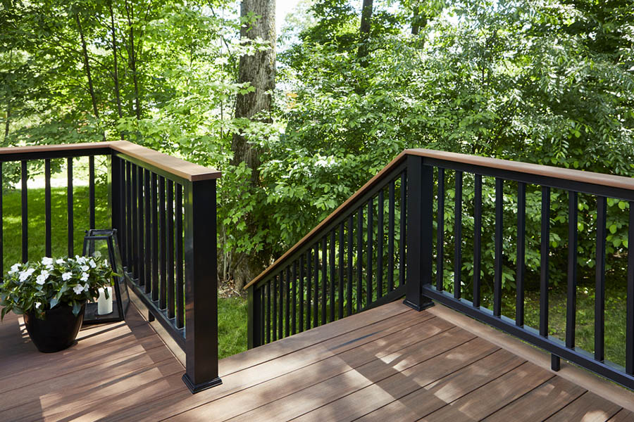 Create an inviting woodland deck with deck top rail ideas like Mahogany composite Drink Rail