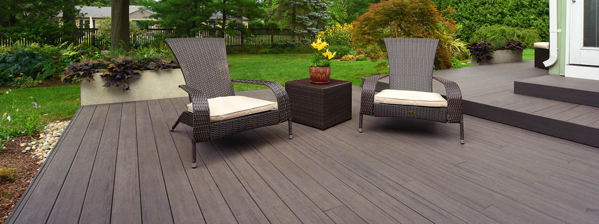 Easy deck ideas include a low multi-level deck in a lush green yard