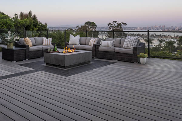 Modern deck design with a sleek black metal railing with glass panel infills