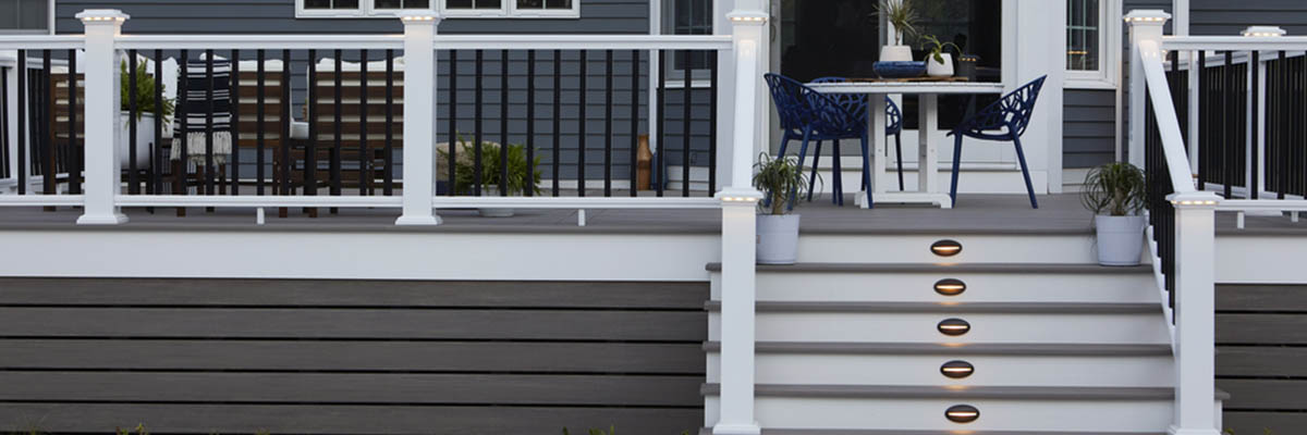 Mid-level composite deck featuring a black and white composite railing design