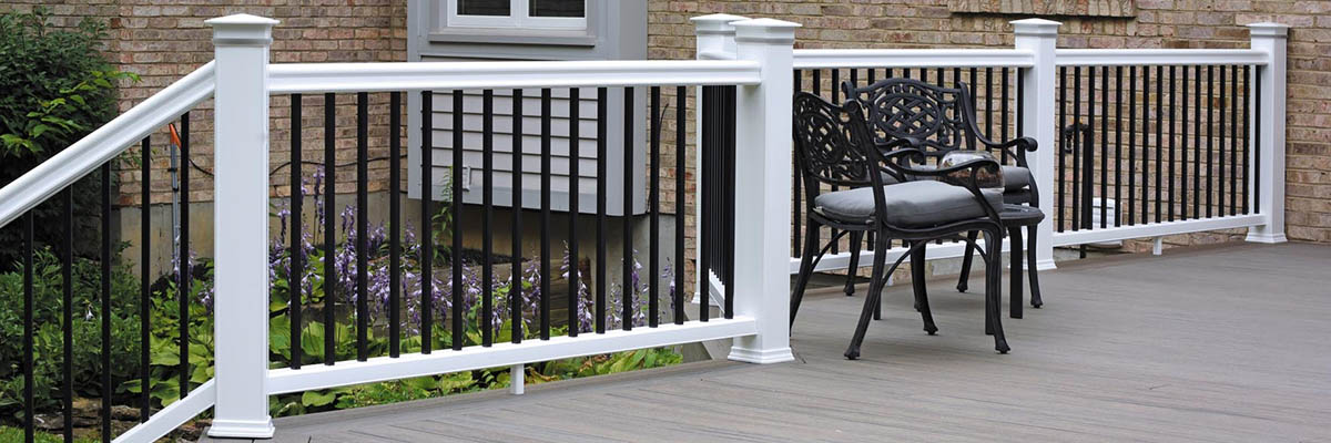 Gray composite deck with a crisp white composite railing and black balusters