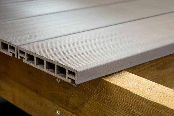 Close up shot of hollow PVC deck boards shows their plastic appearance