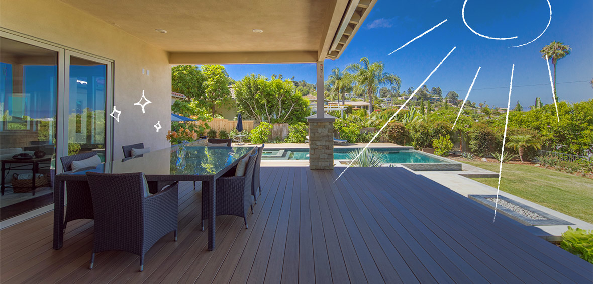 Outdoor dining table under a covered deck near a pool.