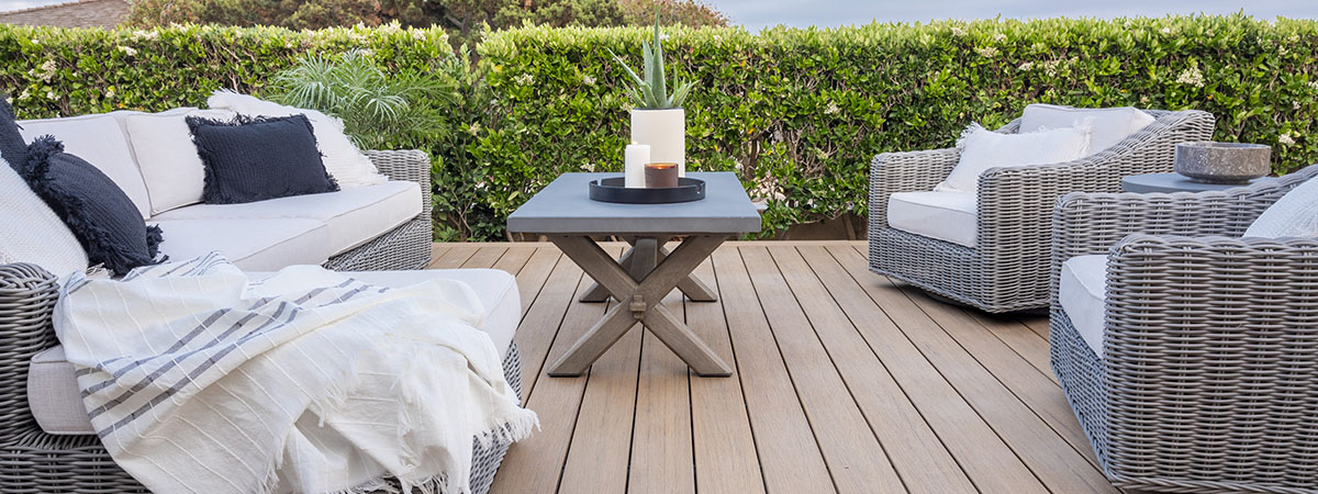 https://www.timbertech.com/wp-content/uploads/2022/04/Deck-Decorating-Ideas-TimberTech-Antique-Leather-Reserve-Collection-PRO-Decking-Coastal-Style-Furniture-Hero.jpg