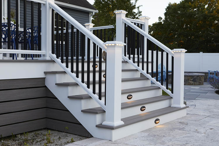 Deck lights in the stairs and railing of a gray composite deck increase ambience and visibility